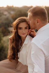 Loving wedding couple outdoor in the rays of the sunset