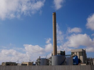 Industrial complex with blue sky and clouds