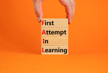 FAIL first attempt in learning symbol. Wooden blocks with words FAIL first attempt in learning. Beautiful orange table, orange background, copy space. Business, FAIL first attempt in learning concept.