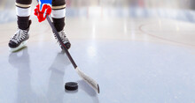 Close Up Of Ice Hockey Player With Stick On Ice Rink Controlling Puck