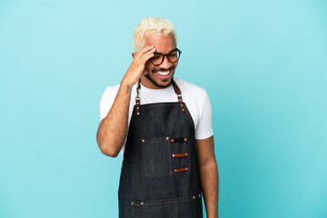 Canvas Print - Restaurant Colombian waiter man isolated on blue background laughing