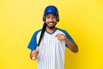 Wall Mural - Young Colombian latin man playing baseball isolated on yellow background with surprise facial expression