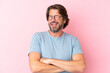 Senior dutch man isolated on pink background With glasses and happy expression