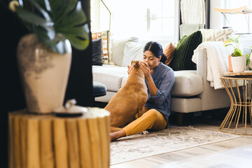 Wall Mural - Woman Kissing Dog At Home