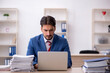 © Elnur - Young male employee and too much work in the office