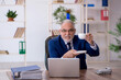 © Elnur - Old male employee drinking coffee during break