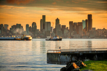 Wall Mural - Seattle Skyline at Dawn. Sunrise on Elliott Bay when marine traffic is active with ferries and tugboats crisscrossing the water with the beautiful city skyline in the background.