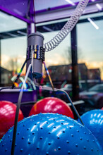 Arcade Claw Grabber Machine With Target Descending On A Toy Ball. Seen Through Smudged Glass