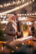 © luckybusiness - Couple enjoying at christmas festival on a snowy weather