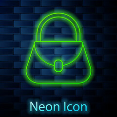 Poster - Glowing neon line Handbag icon isolated on brick wall background. Female handbag sign. Glamour casual baggage symbol. Vector Illustration