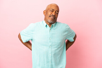 Wall Mural - Cuban senior isolated on pink background suffering from backache for having made an effort