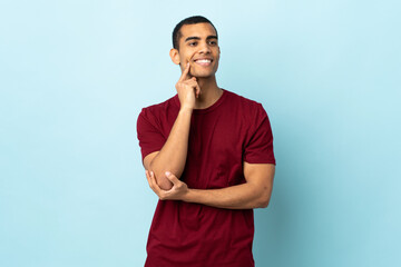 African American man over isolated background thinking an idea while looking up