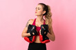 © luismolinero - Young Brazilian woman isolated on pink background with boxing gloves