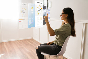 beautiful woman touching a virtual reality interface