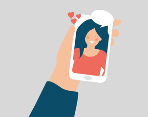 A hand holds a phone and talk in a video call with a happy girl or woman on the screen display. Speech bubble, online smartphone conversation, social media, Couple relationship and friendship concept.