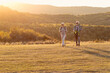 © pucko_ns - Old couple walking in nature and talk at sunset