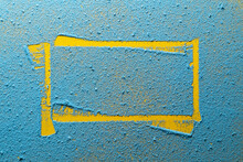 Imprint Of A Yellow Irregular Frame On A Bright Blue Powder. Copy Space. Abstract Background. Top View. 