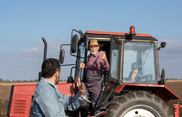 Sticker - Farmers talking beside tractor in field