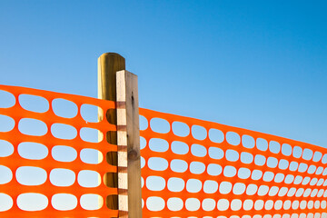 Perforated safety orange plastic grid to delimit construction si