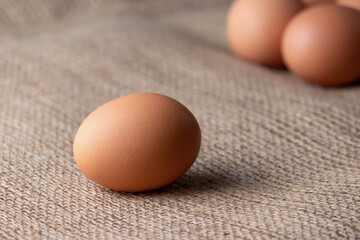 Wall Mural - fresh eggs on jute cloth