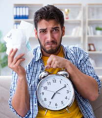 Man frustrated at bills he needs to pay in time management conce