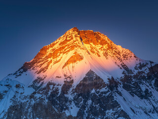 Wall Mural - Snow spot of last light on summit Everest under blue sky in Nepal