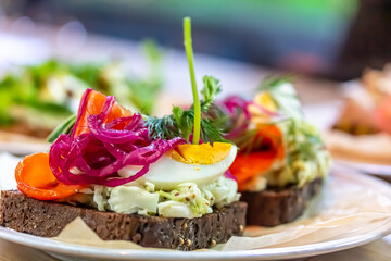 Wall Mural - Traditional Danish sandwich, Smerrebred with salted salmon, pickled onion, egg and salad on rye bread.