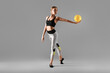 © Pixel-Shot - Beautiful young woman doing gymnastics with ball on grey background