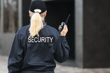 Female Security Guard Outdoors, Back View