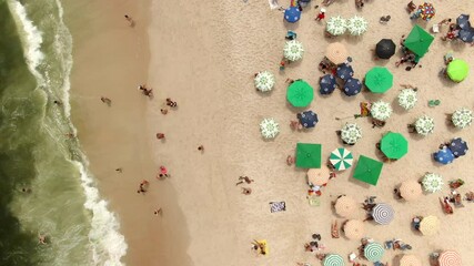 Wall Mural - Top down aerial view of people enjoying the summer at Ipanema Beach in Rio de Janeiro, Brazil.