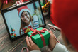 © weedezign - Christmas and new year  video call with friend with tablet exchange gift together at home