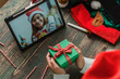 © weedezign - Christmas and new year  video call with friend with tablet exchange gift together at home