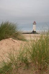 Wall Mural - beautiful sunrise landscape image of talacre beach lighthouse at surnise with dramatic sky and cloud