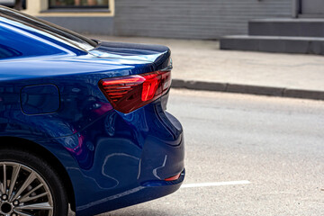 Wall Mural - rear half with rear lights of a parked car on the side of the street, vehicle exterior details