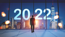 Businessman Standing In Office Room, Looking At New York Panorama With 2022 Icon