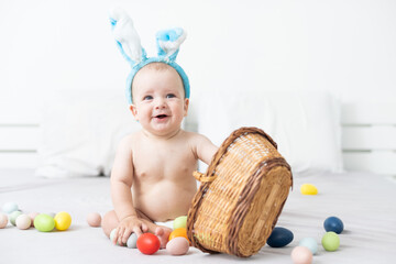 happy caucasian baby girl six months old wearing bunny ears headband