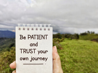 Wall Mural - Inspirational Quote - Be patient and trust your own journey. Text written on notepad background. Stock photo.