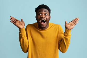 Surprised african american guy looking at camera, gesturing