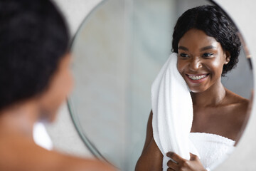 Wall Mural - Beautiful african american woman enjoying morning beauty routine