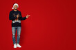 © Prostock-studio - African american man in Santa hat pointing at copy space