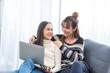 © lukyeee_nuttawut - Asian young lover lesbian couple doing planning wedding with computer notebook with happy in love moment in living room  - LGBT relationship in daily lifestyle concept