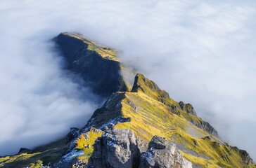 Poster - Mountains and clouds in the valley. Natural landscape high in the mountains.