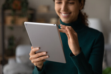 Poster - Crop close up of smiling Latino woman use tablet gadget talk speak on webcam call online. Happy Hispanic female hold pad device browse wireless internet or shop on web. Communication concept.