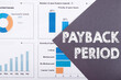 The word PAYBACK PERIOD is written on a gray background with diagrams and graphs.