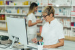 © Zamrznuti tonovi - Senior female pharmacist working in a pharmacy