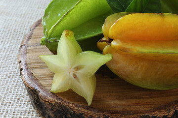 Tasty carambola fruit on wooden table.