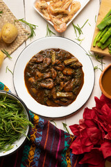 Wall Mural - Mexican romeritos with mole sauce and shrimp on a white background