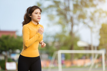 Wall Mural - woman running in the park in early morning