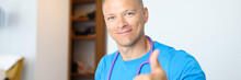 Smiling Male Doctor Making Thumbs Up Gesture