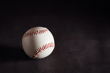 Wall Mural - Baseball ball on dark brown background with copy space